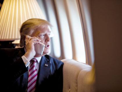 Hamas - President Donald Trump talks on the phone aboard Air Force One during a flight to