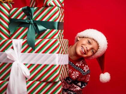 child with Christmas presents