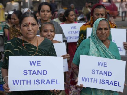 People hold placards in solidarity with Israel in Ahmedabad, India, Monday, Oct. 16, 2023.